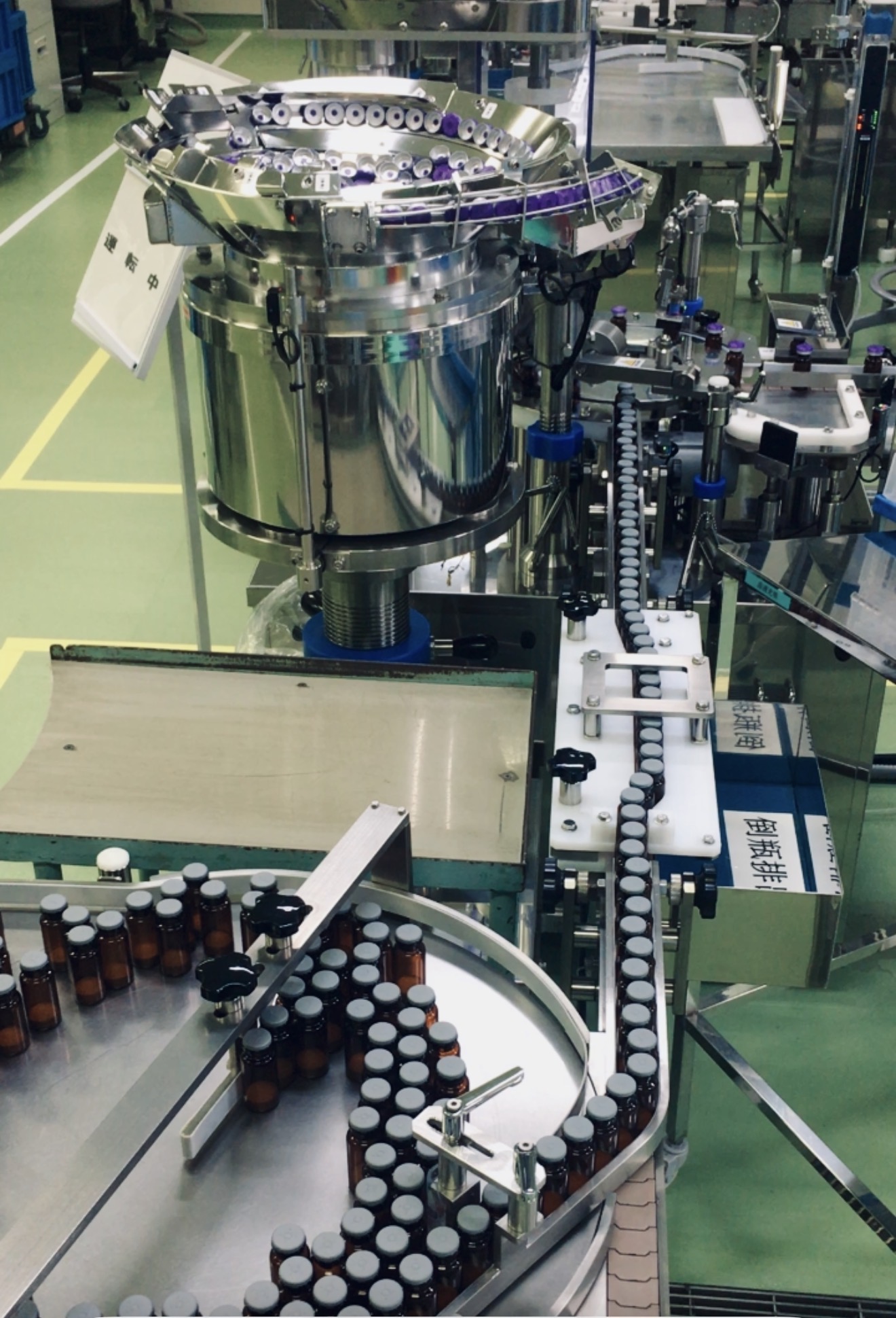 Bottles travelling through a manufacturing production line